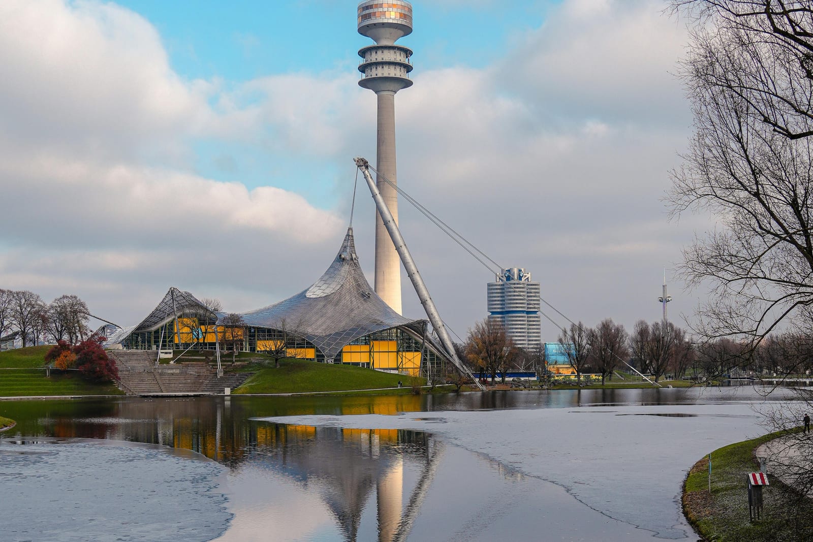 Olympiapark tower and tent-roof architecture reflected in the lake in Munich